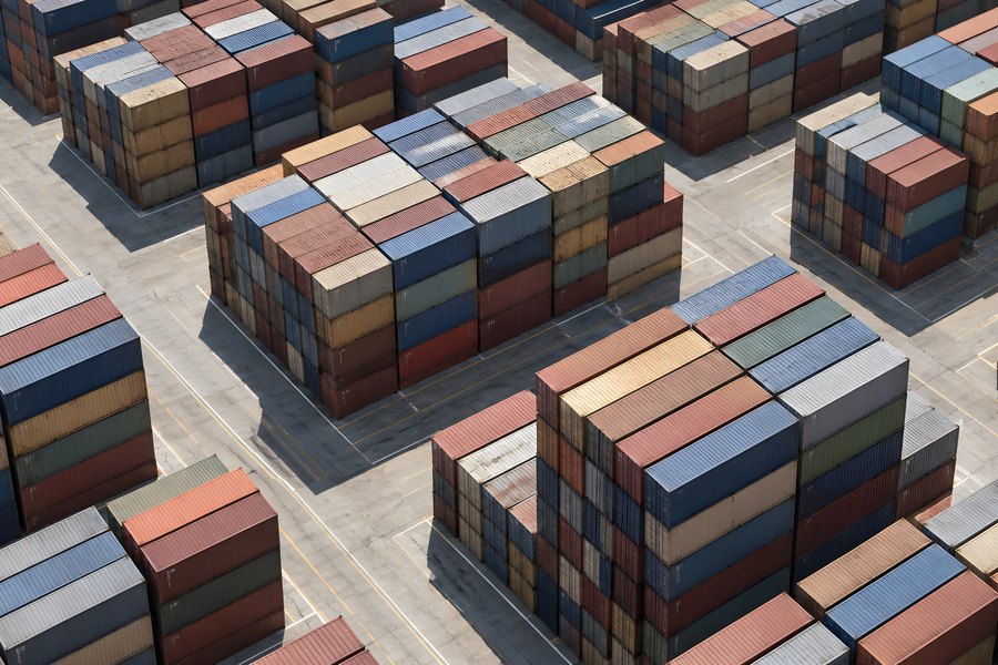 Aerial View of Colorful Shipping Containers Stacked in a Port Terminal Yard