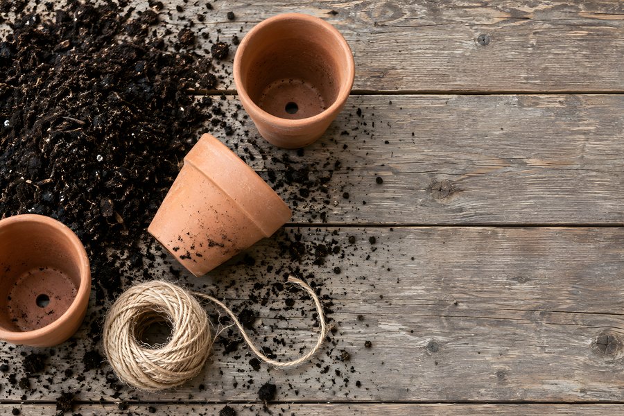 Empty Terracotta Pots and Spilled Potting Soil on a Rustic Wooden Potting Bench with Jute Twine, Flat Lay with Copy Space