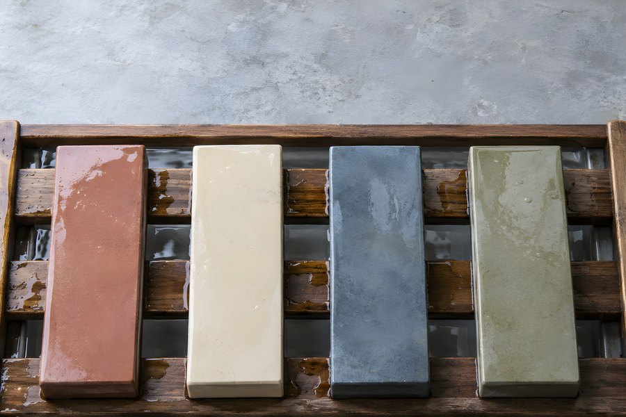 Four Colorful Whetstones Soaking on a Wooden Rack for Knife Sharpening, Overhead View